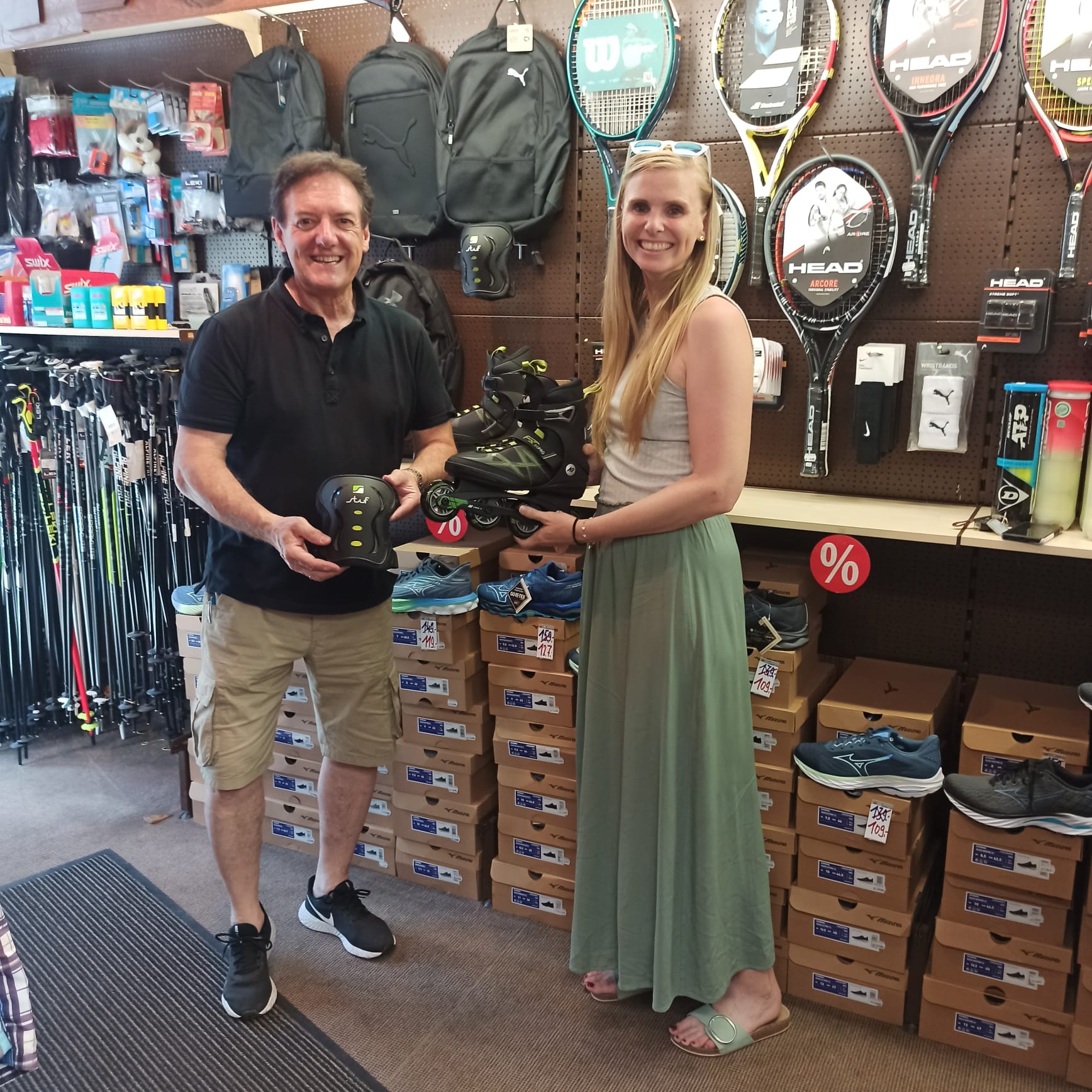 Geschäftsinhaber Rolf Schwarztrauber und Lehrerin Jennifer Keil stehen im Sportgeschäft und präsentieren Inline-Skates